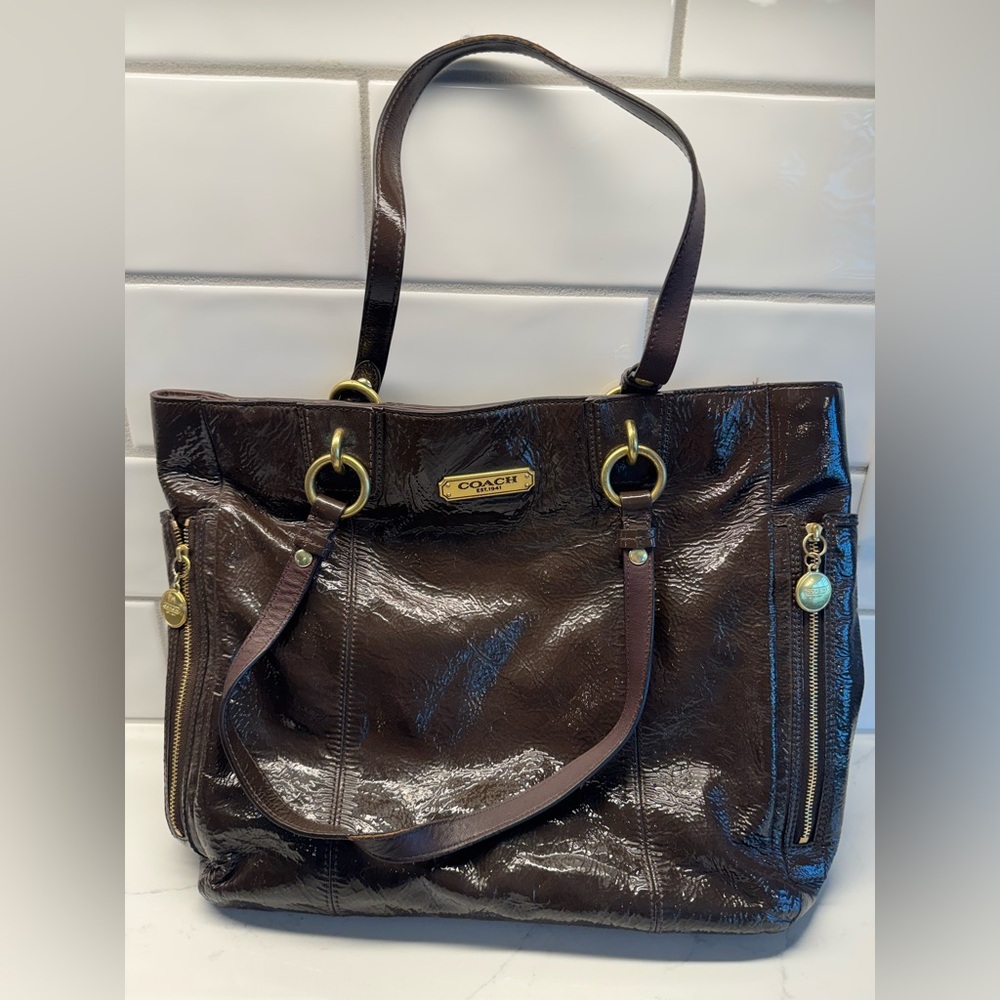 Coach Brown Patent Leather Tote Bag
Zipper close on top